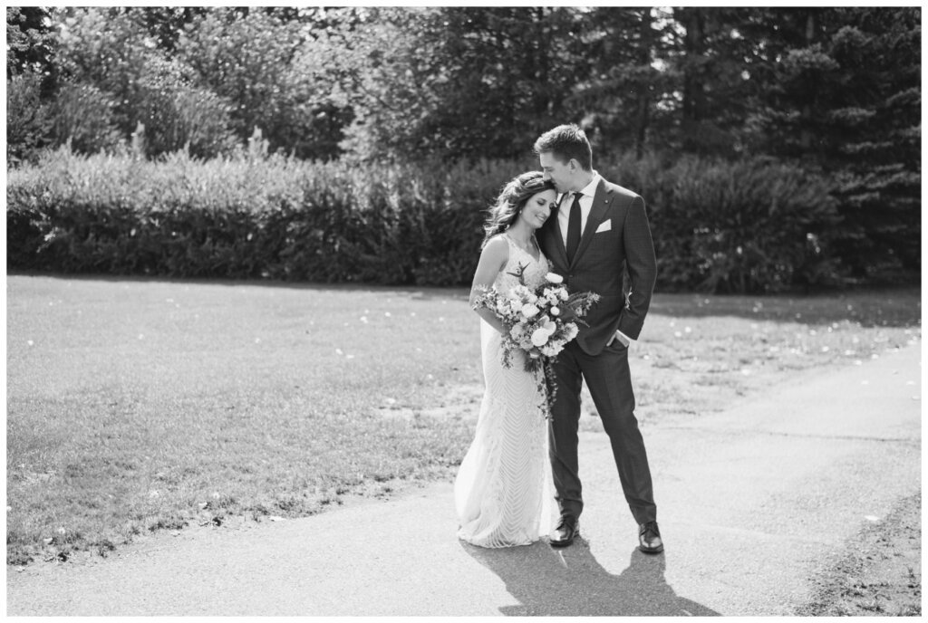 Taylor & Jolene - Emerald Park Wedding - 10 - Bride & Groom on walking path in White City