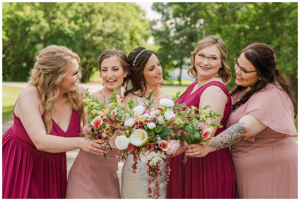 Taylor & Jolene - Emerald Park Wedding - 26 - Bride with her bridesmaids dressed in pink