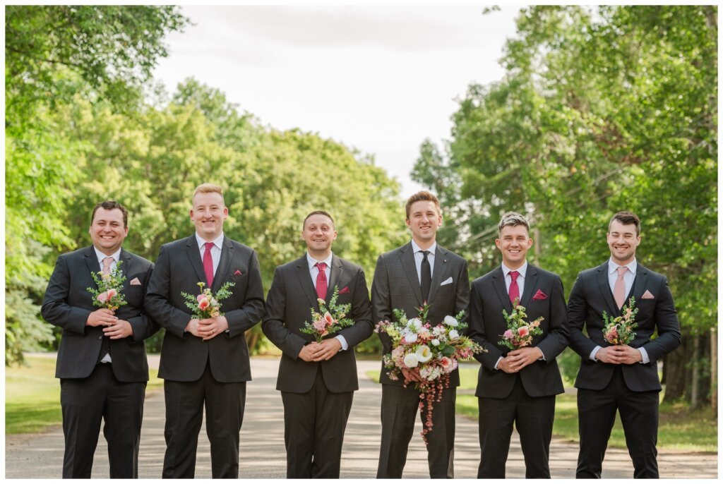 Taylor & Jolene - Emerald Park Wedding - 27 - Groom and groomsmen accessorize with bouquets