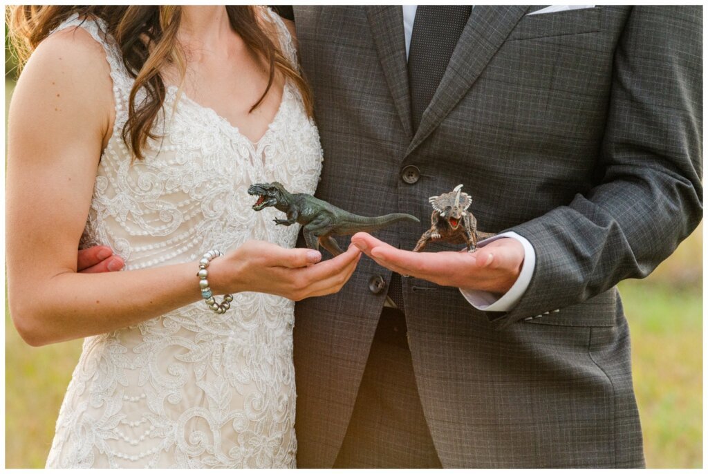 Taylor & Jolene - Emerald Park Wedding - 41 - Bride & Groom with dinosaurs