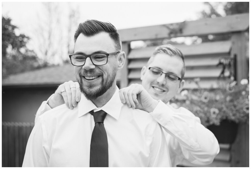 Andrew & Lacey - 04 - Groomsman helping groom with final prep