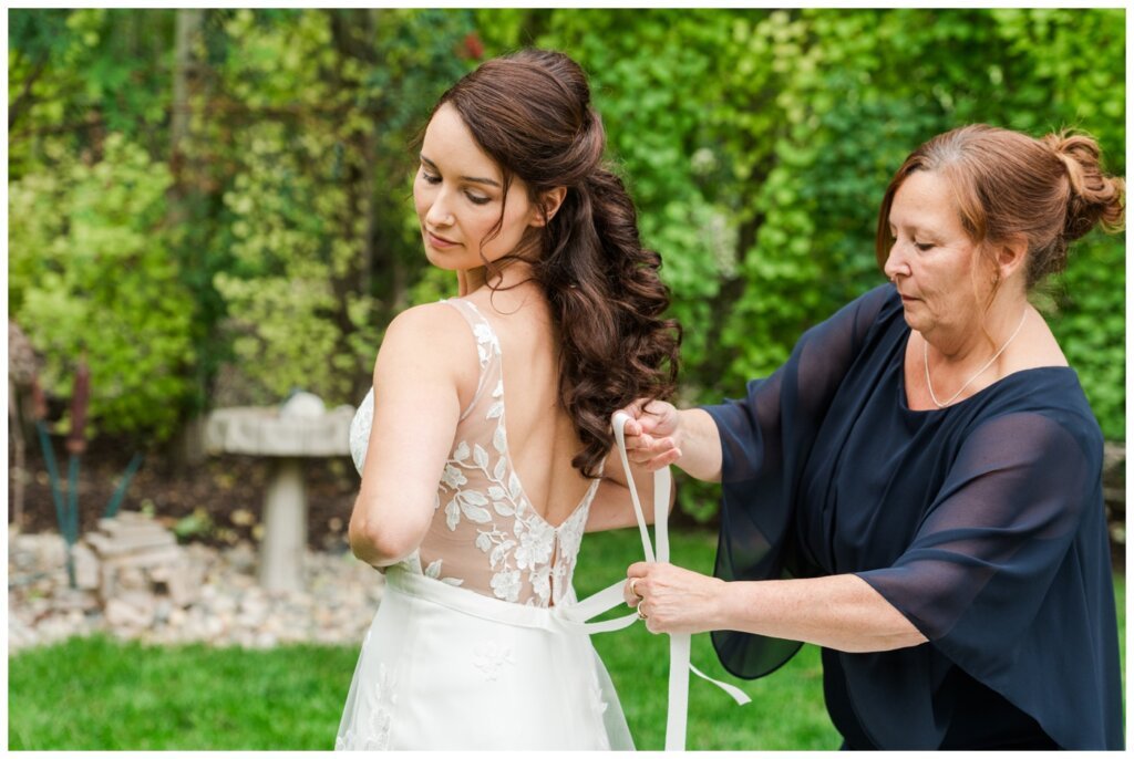 Andrew & Lacey - 07 - White City Bride Prep with mother of the bride doing up the dress