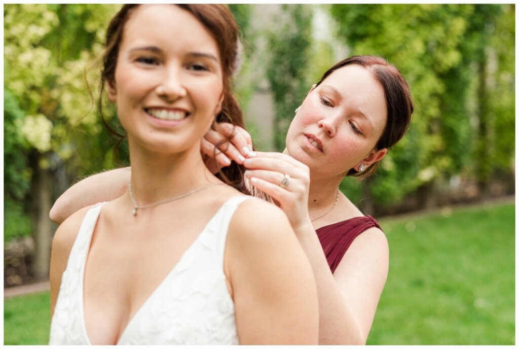 Andrew & Lacey - 08 - Sister of the bride putting necklace on bride