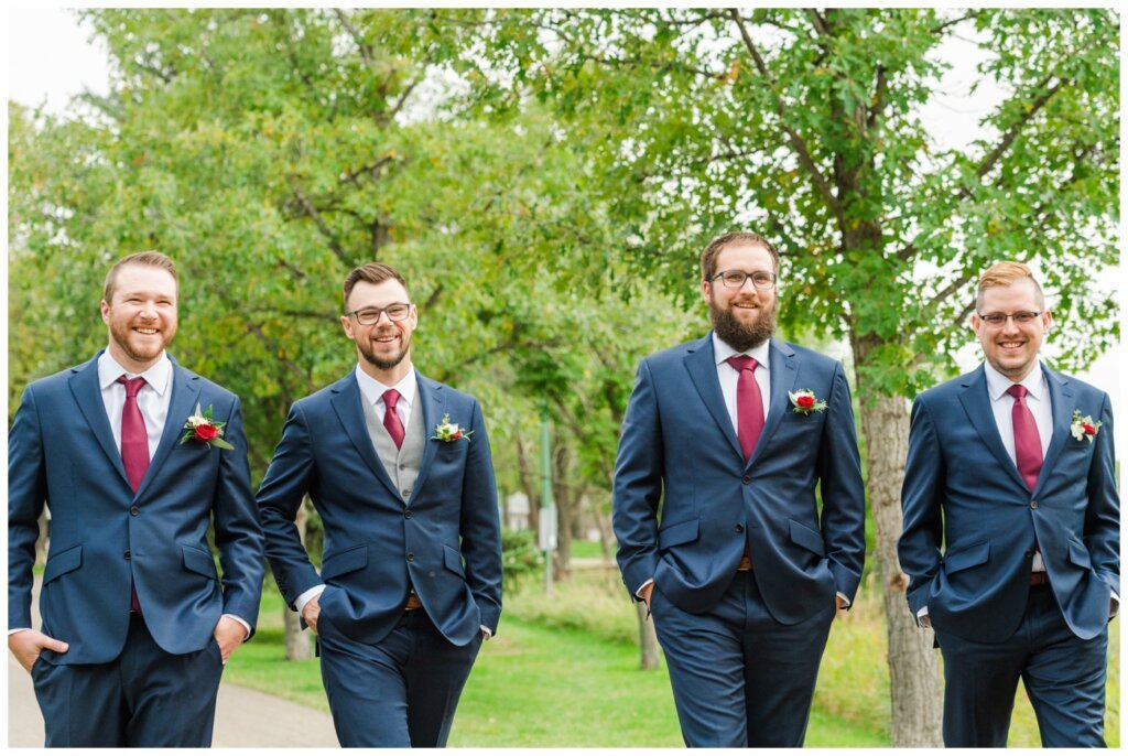 Andrew & Lacey - 22 - Groom & Groomsmen walking near Rotary Park