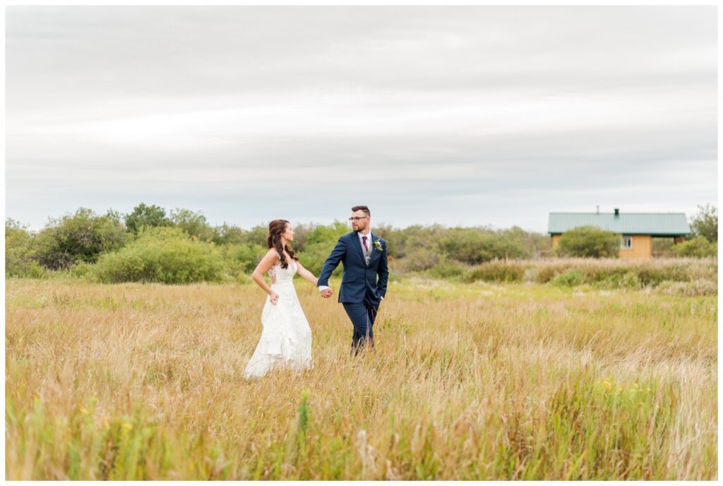 Andrew & Lacey - 37 - Bride & Groom walking at White Butte Trail