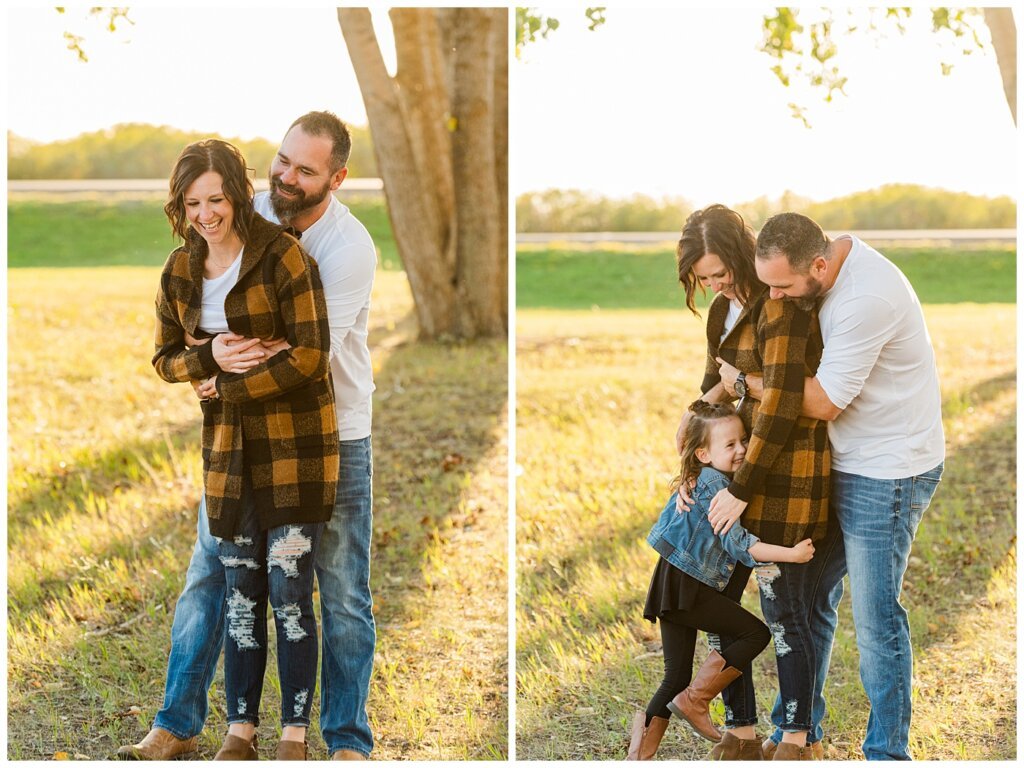 Kim & Lisa Korchinski - White Butte Trails - Family Photo Session 2021 - 04 - Husband and wife cuddle and daughter runs up to them