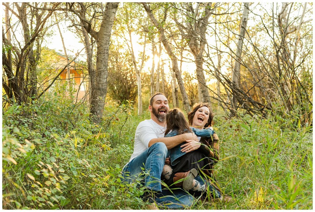 Kim & Lisa Korchinski - White Butte Trails - Family Photo Session 2021 - 08 - Daughter running and jumping on parents as they sit