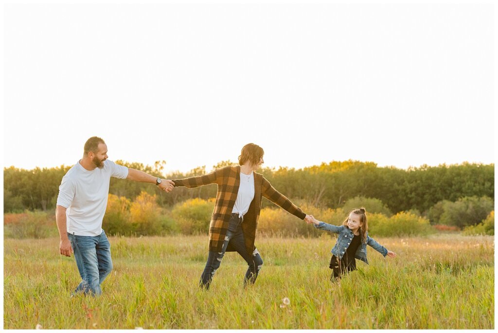 Kim & Lisa Korchinski - White Butte Trails - Family Photo Session 2021 - 12 - Daughter leading parents through field