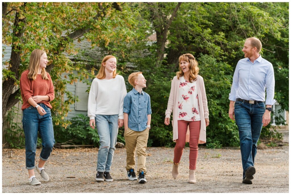 Schoenroth Family - Cathedral Village Regina - 01 - Family laughs as they walk through alley