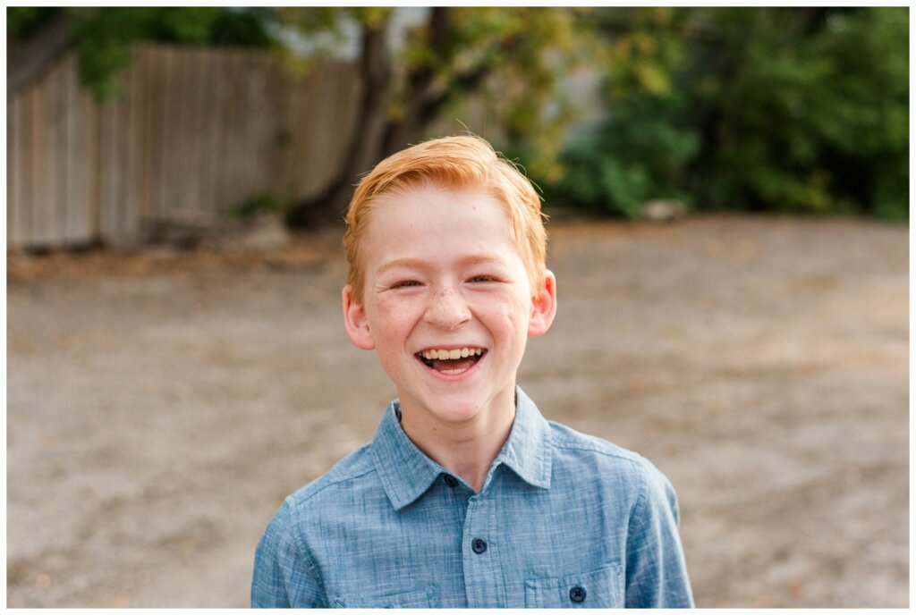 Schoenroth Family - Cathedral Village Regina - 04 - Little boy in denim shirt laughs