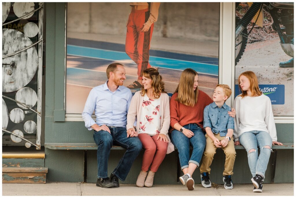 Schoenroth Family - Cathedral Village Regina - 10 - Family sits on bench outside of Iannone's