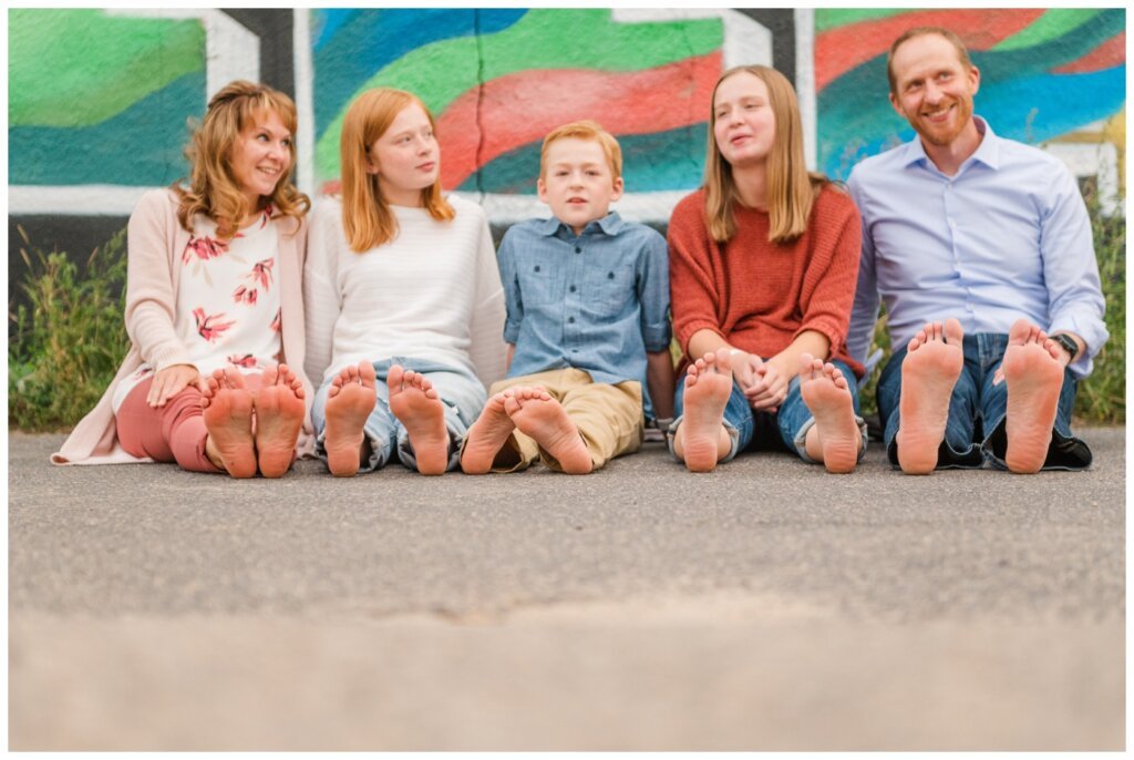 Schoenroth Family - Cathedral Village Regina - 16 - Family sit barefoot in the alley