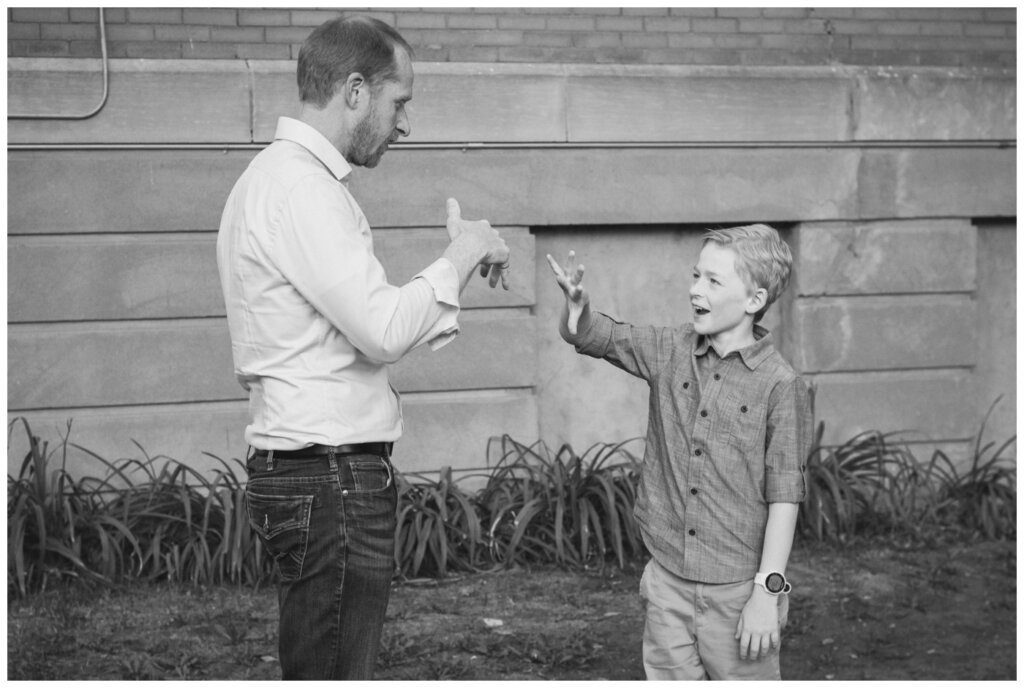 Schoenroth Family - Cathedral Village Regina - 18 - Father and son with their secret handshake