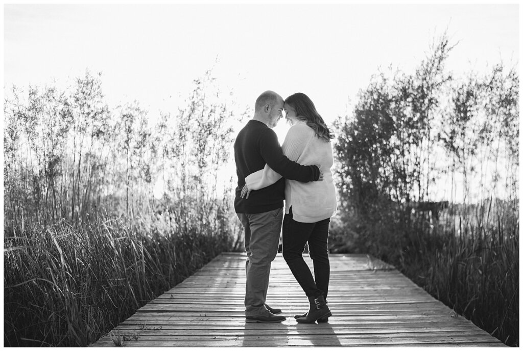 Trevor & Kim - Regina Engagement Session - Wascana Centre Habitat Conservation Area - 10 - Black and white photo of couple on dock