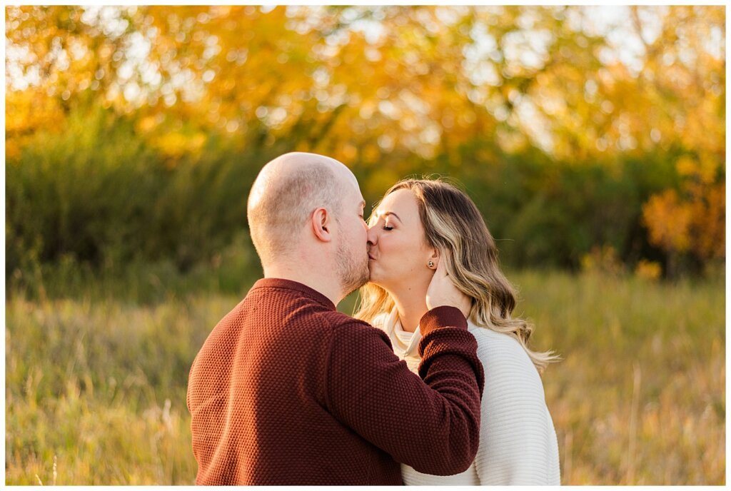 Trevor & Kim - Regina Engagement Session - Wascana Centre Habitat Conservation Area - 12 - Couple Kissing in field