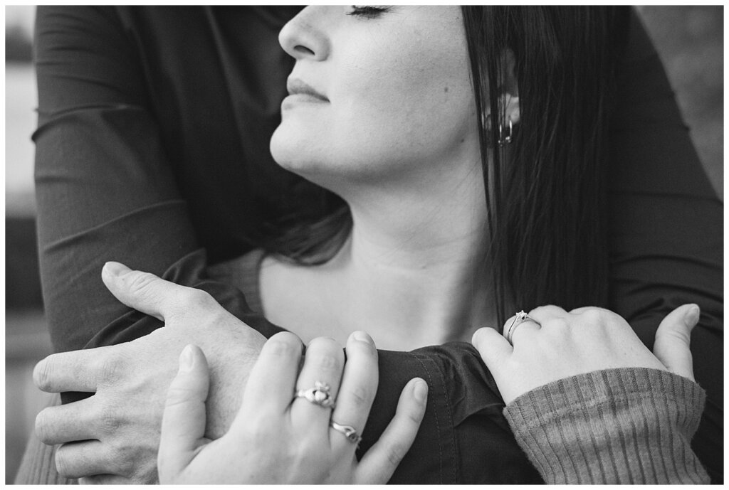 Andrew & Alisha - Regina Engagement Session - 13 - Black and white photo of ring as man wraps arms around fiancee
