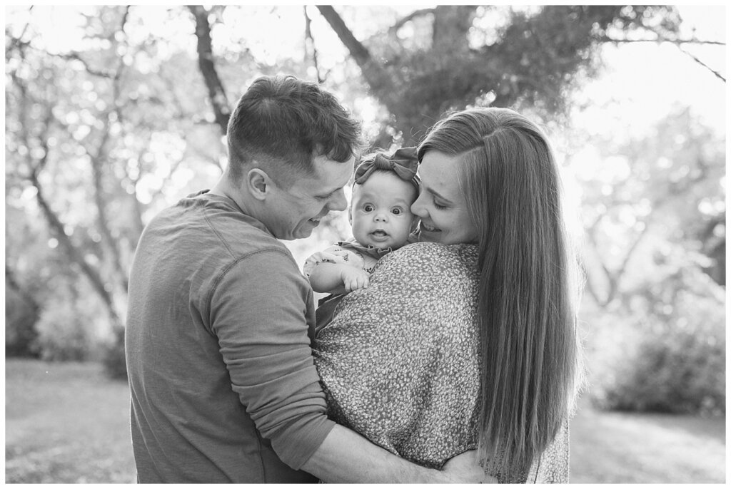 Filby Family - Regina Family Photography - Wascana Park - 09 - Baby Isla looking over parents shoulder