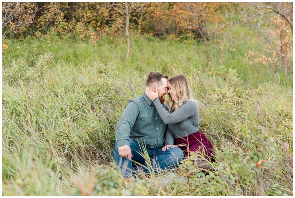 Jared & Jenna - Wascana Trails - 03 - Couple sitting on the ground nose to nose