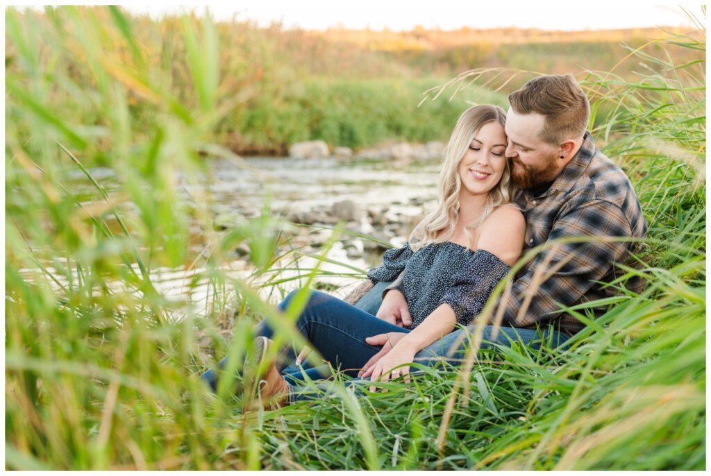 Jared & Jenna - Wascana Trails - 08 - Couple sitting on the bank of a creek