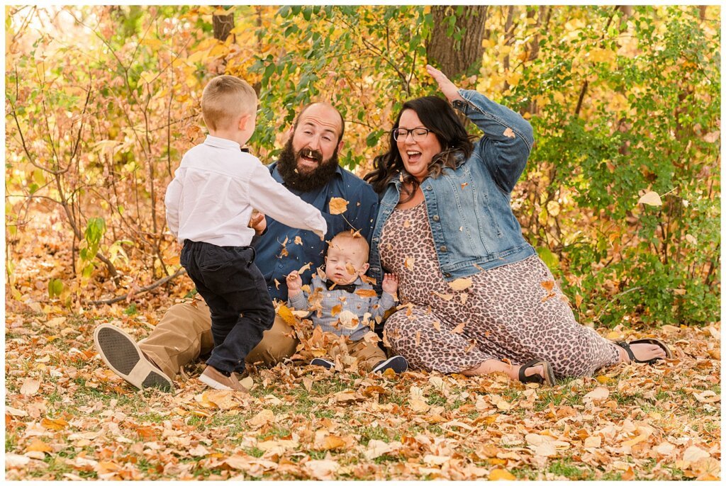 Nickel Family - Regina Science Centre - Family Photo Session - 03 - Older brother throwing leaves at family