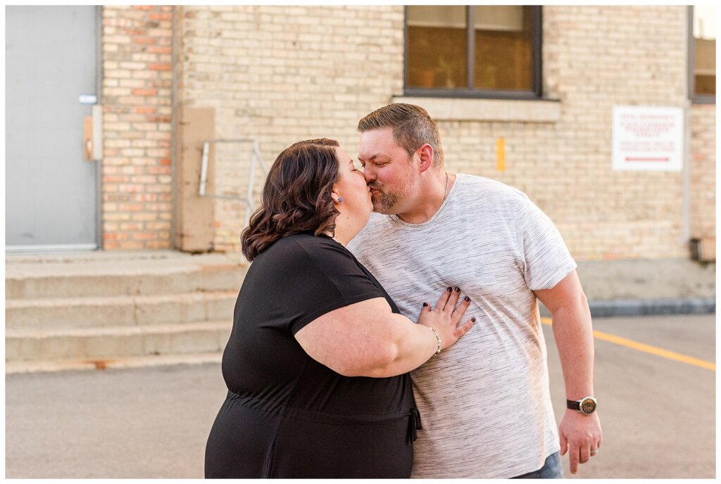 Regina Couples Photo Session - Scott & Ashley 2021 - Regina Warehouse District - 02 - Couple kissing as they walk