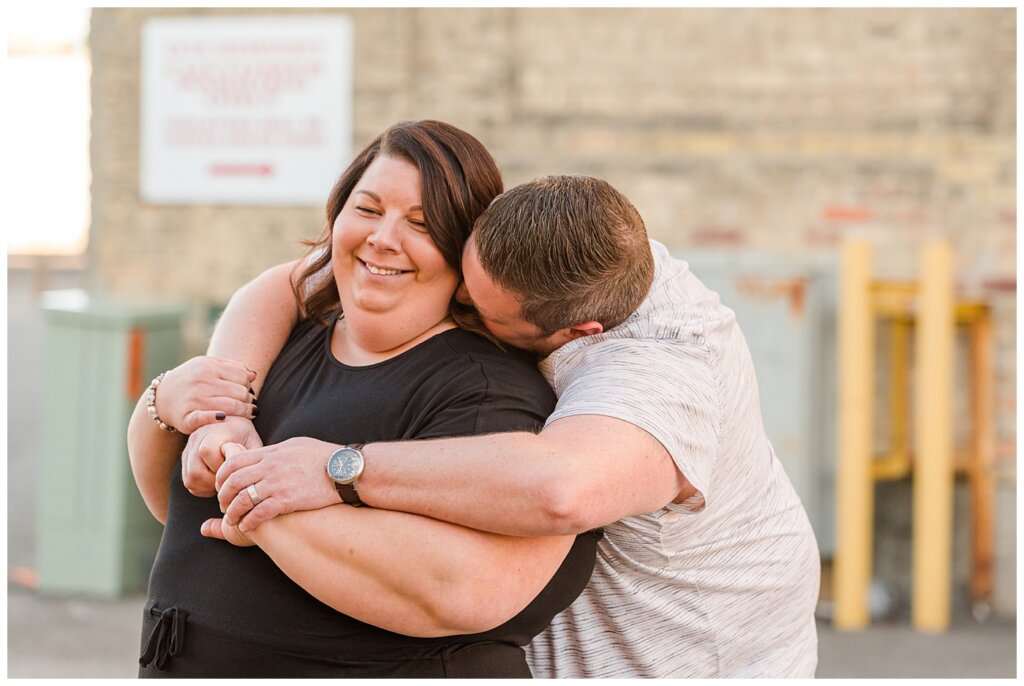 Regina Couples Photo Session - Scott & Ashley 2021 - Regina Warehouse District - 04 - Scott nuzzling into Ashley's neck
