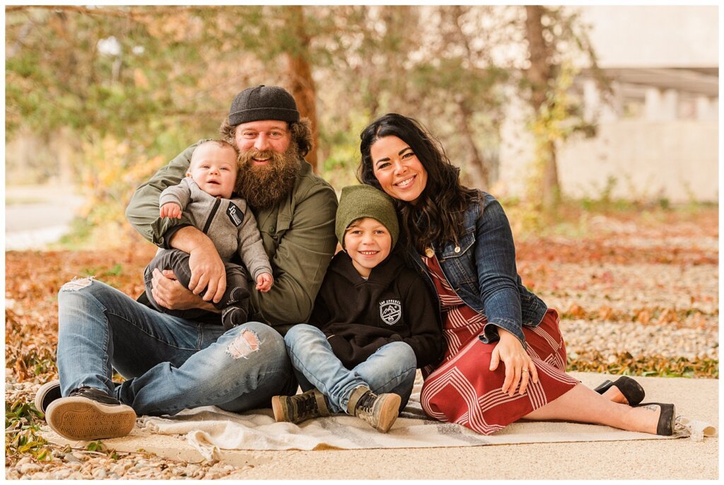 Regina Family Photographers - Keen Family - 2021 - TC Douglas Building - 09 - Family of 4 sittingo on blanket