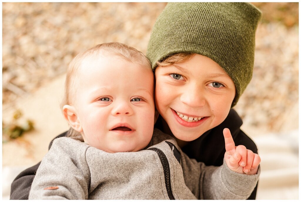 Regina Family Photographers - Keen Family - 2021 - TC Douglas Building - 10 - Little brother pointing at big brother