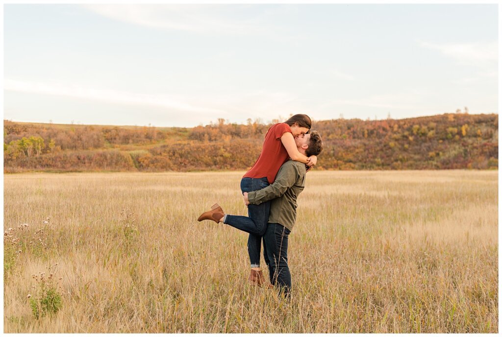 Tris & Jana - Engagement Session - Wascana Trails - 08 - Deer Valley Couple lifting up fiancee