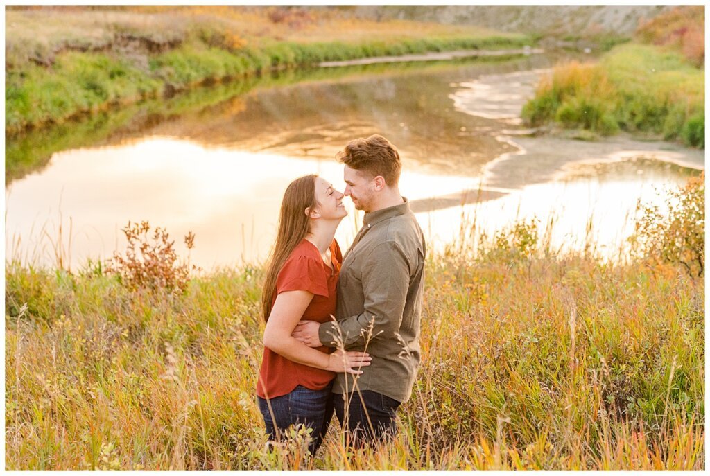 Tris & Jana - Engagement Session - Wascana Trails - 12 - Standing near Wascana Creek