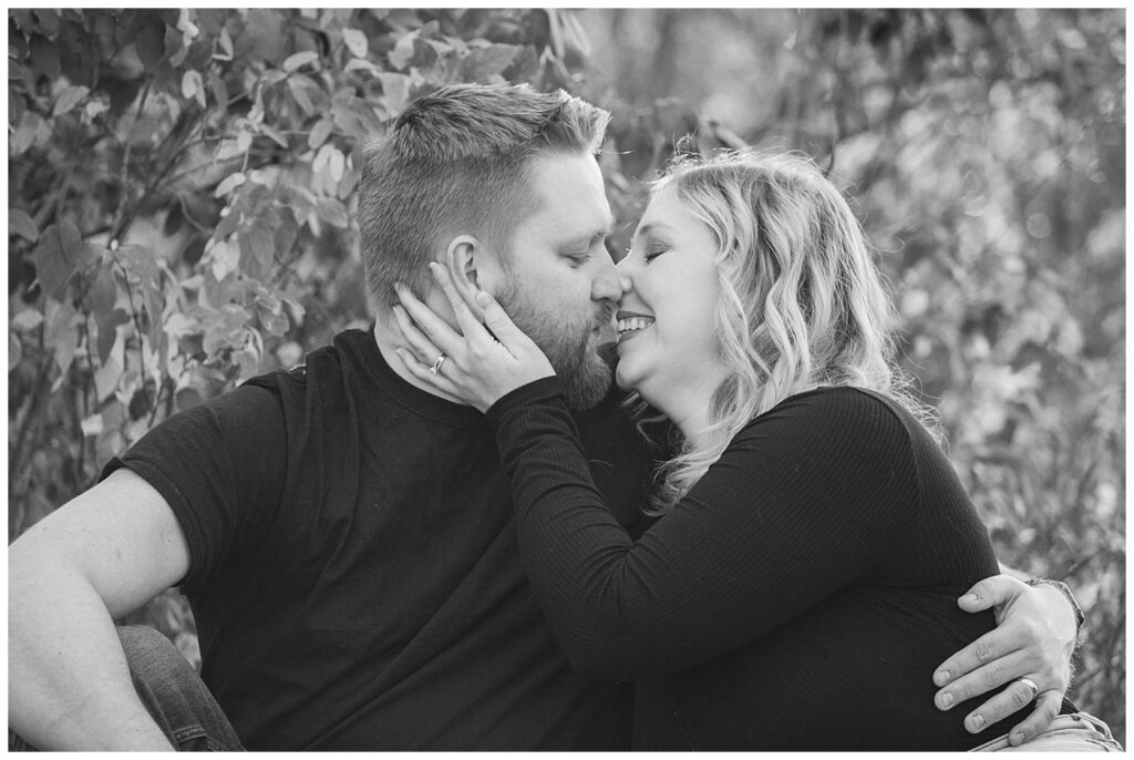 Tyrel & Allison - Regina Anniversary Session - Douglas Park Hill - 04 - Black and white of Husband and Wife kissing in park