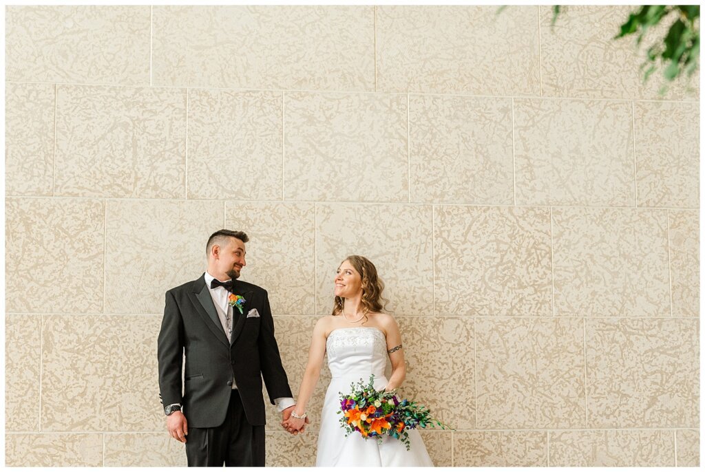 Matt & Ruth - 2022 Wedding - TC Douglas Building - Regina Wedding - Bride & Groom holding hands