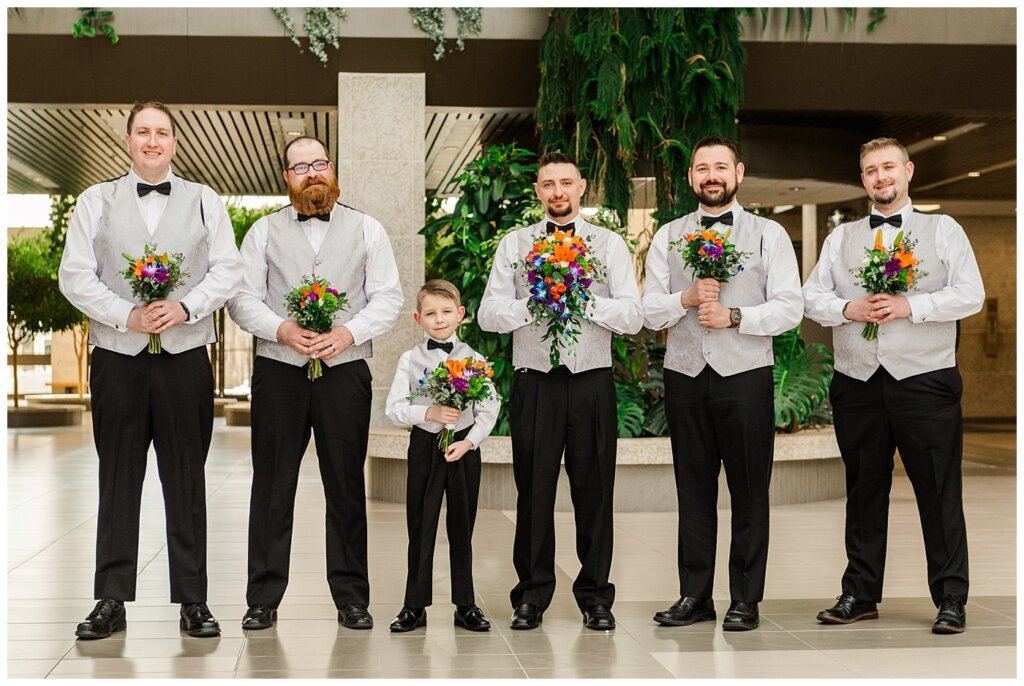 Matt & Ruth - 2022 Wedding - TC Douglas Building - Regina Wedding - Groom & Groomsmen with flowers