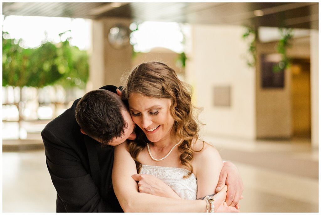 Matt & Ruth - 2022 Wedding - TC Douglas Building - Regina Wedding - Groom kisses into Brides neck