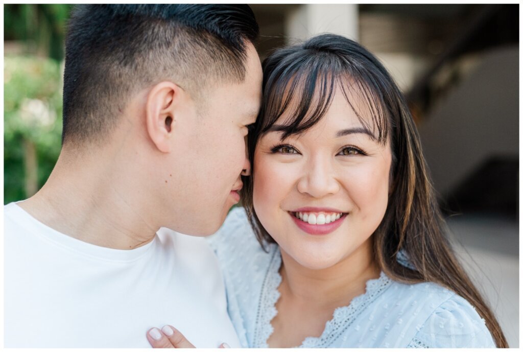 Couple nuzzling together while Sam looks into camera