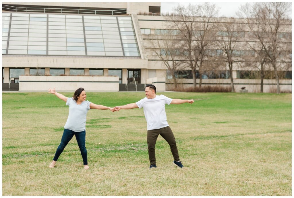 Fun couple dancing outside of Mackenzie Art Gallery