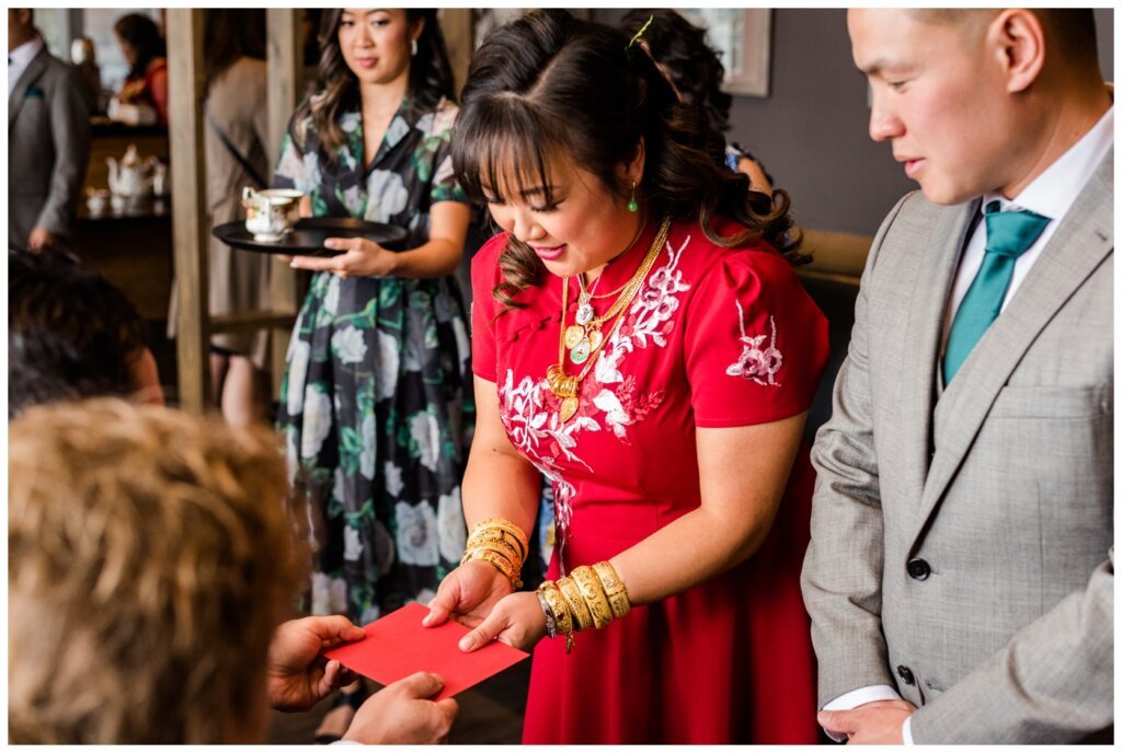 Sam & Benton - Chinese Tea Ceremony - Western Pizza Rochdale - 05 - Bride receives red envelope