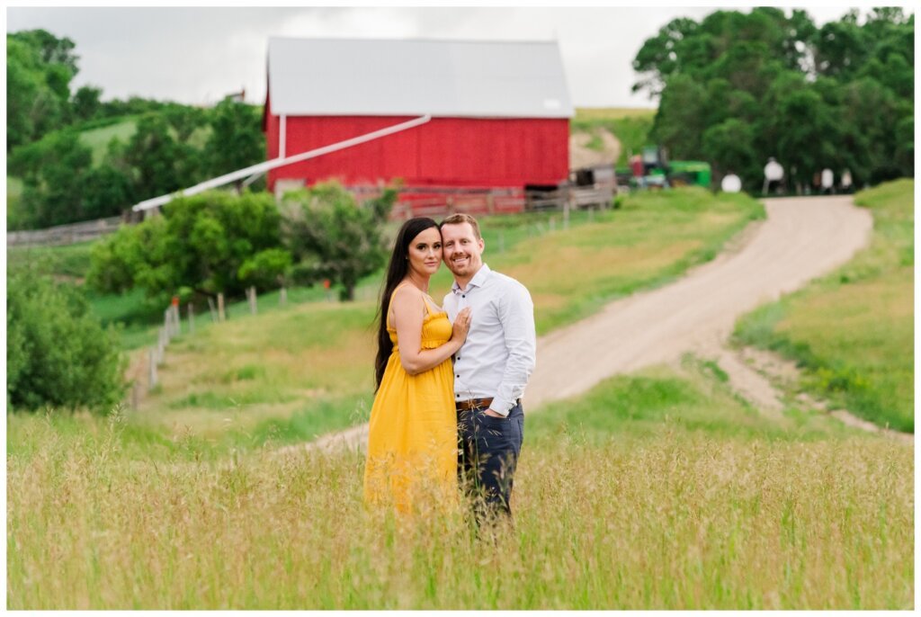 Adam Caitlin 14 Lumsden Valley Couple stands in tall grass in front of the family farm