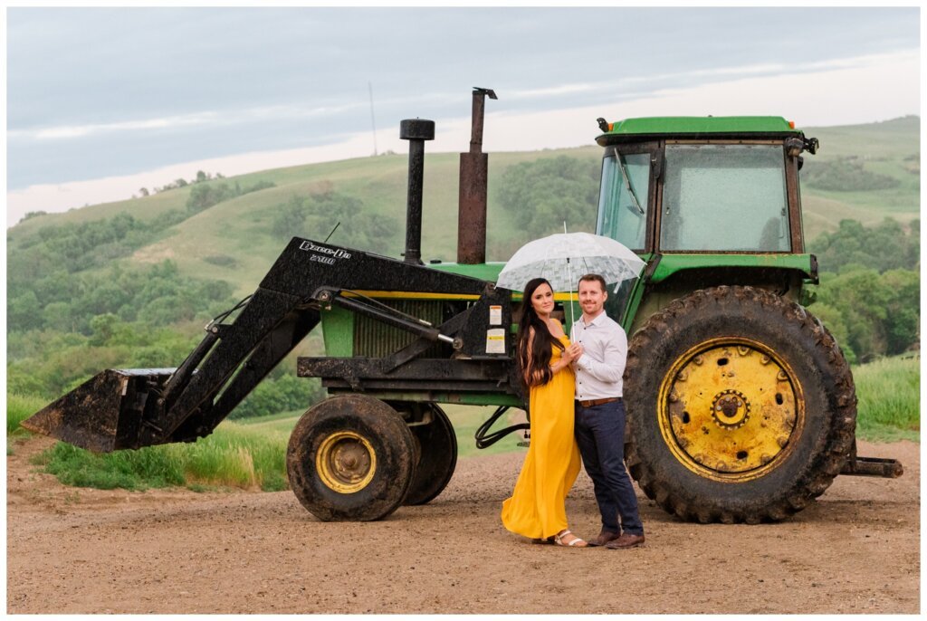 Adam Caitlin 18 Lumsden Valley Couple stands in the rain with John Deere tractor