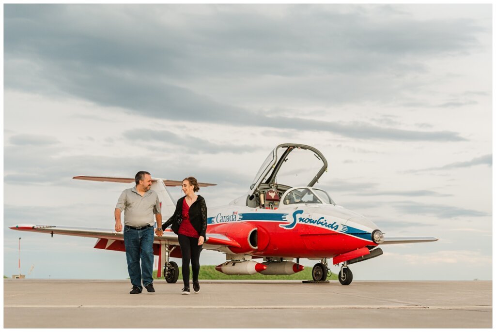 Shawn & Jennifer - 15 Wing Moose Jaw - 01 - Couple walks in front of Snowbird