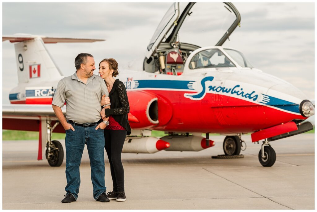 Shawn & Jennifer - 15 Wing Moose Jaw - 02 - Couple stand in front of Snowbird plane