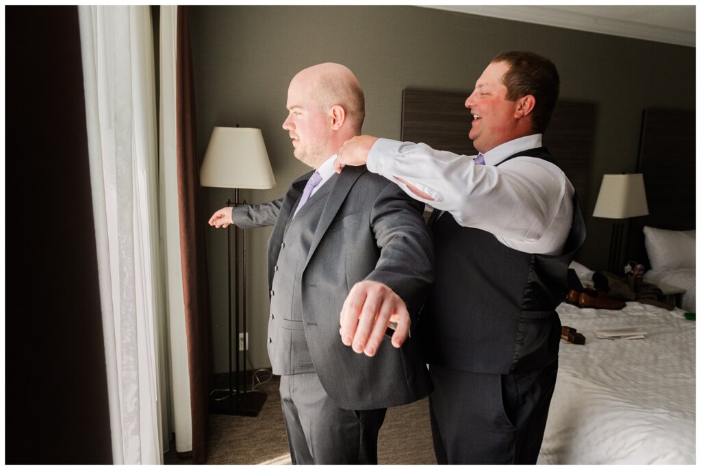 Trevor & Kim - The Atlas Hotel - 07 - Best man helps groom into jacket