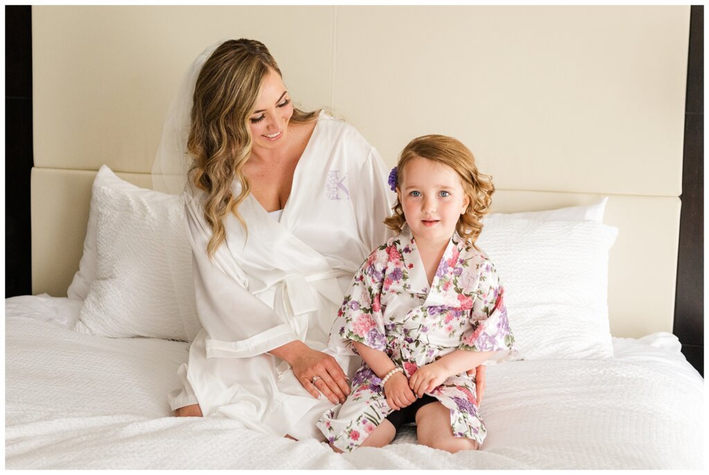 Trevor & Kim - The Atlas Hotel - 09 - Bride & flower girl sit on bed together in wedding day robes