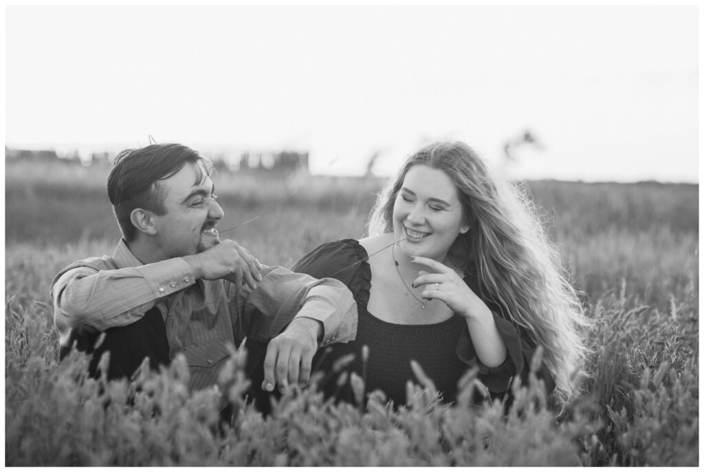 Orrin & Jade - 12 - Weyburn Engagement - Couple plays with chewing tall grass