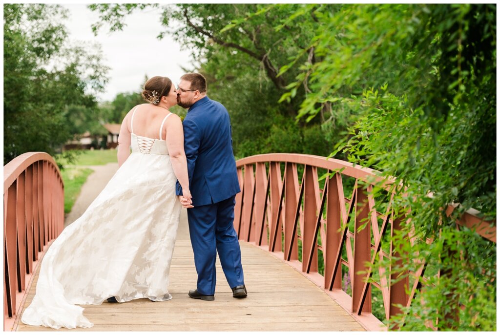 Paul & Lubomyra - Ukrainian Wedding - 17 - Bride and groom kisisng on the bridge at AE Wilson Park