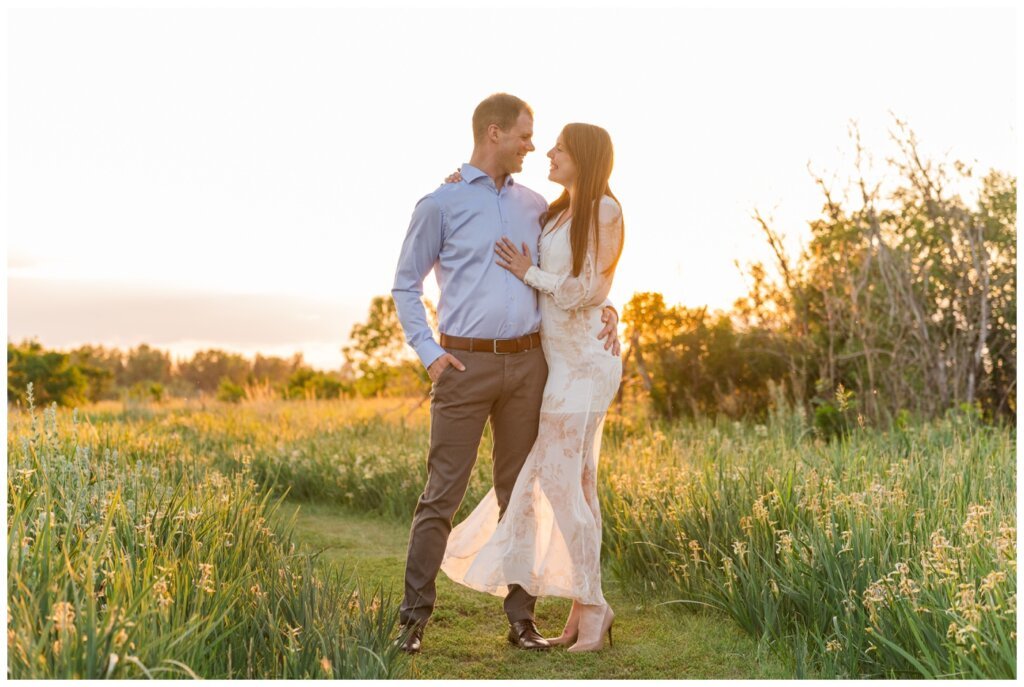 Ryan & Melissa - 11 - Wascana Habitat Conservation Area - Bride & Groom stand in the sunset