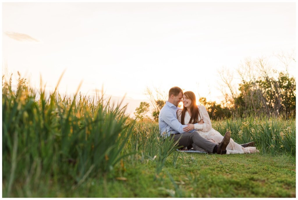 Ryan & Melissa - 12 - Wascana Habitat Conservation Area - Bride & Groom sit in the evening light