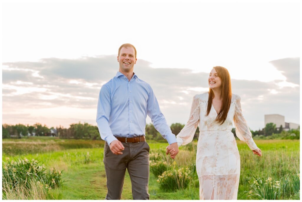 Ryan & Melissa - 14 - Wascana Habitat Conservation Area - Couple walks in dress clothes at sunset