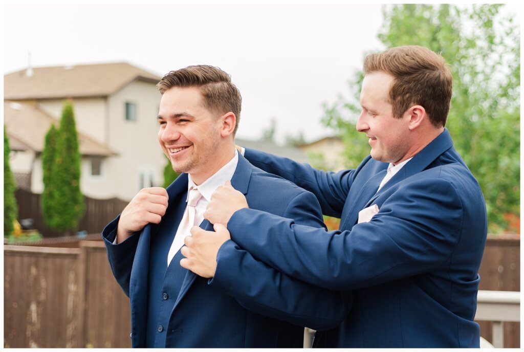 Tris & Jana - Lumsden Wedding - 03 - Groom gets a hand with his suit jacket