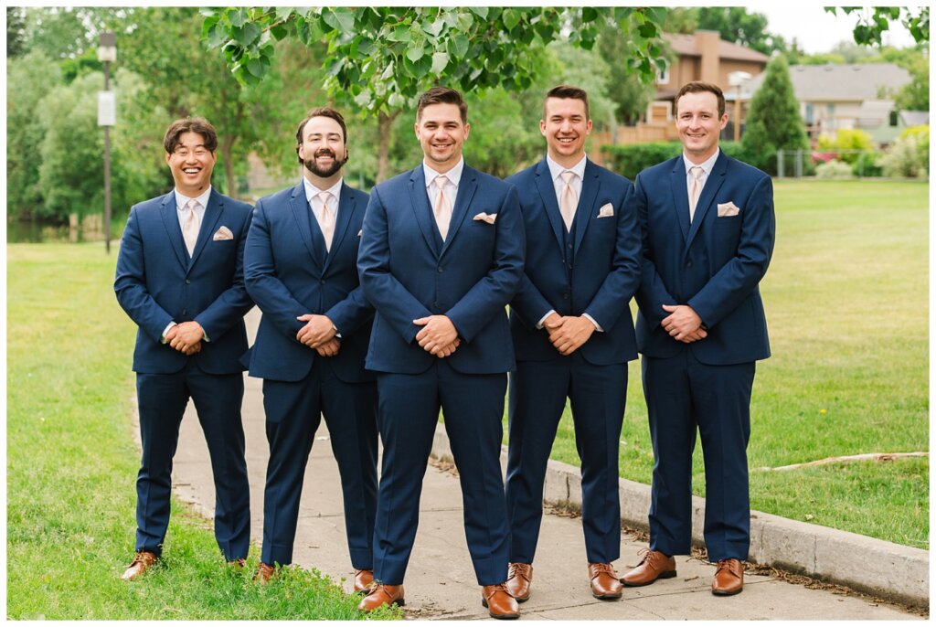 Tris & Jana - Lumsden Wedding - 04 - Groom with groomsmen in navy suits
